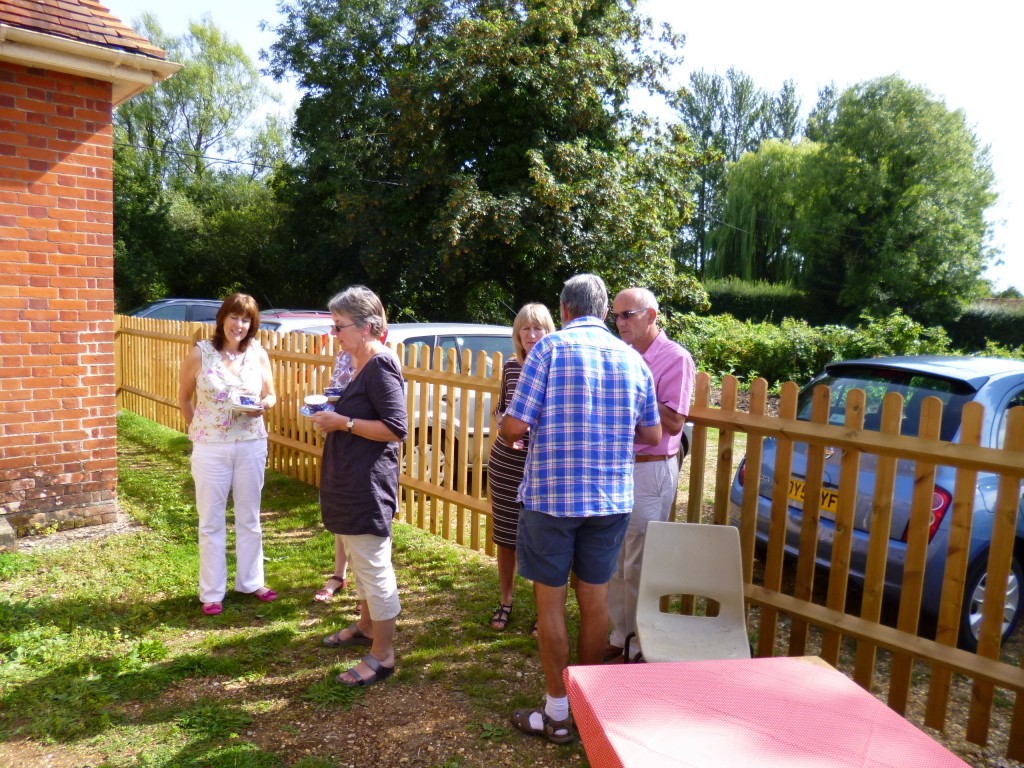 Enjoying catching up over a cream tea in the sun