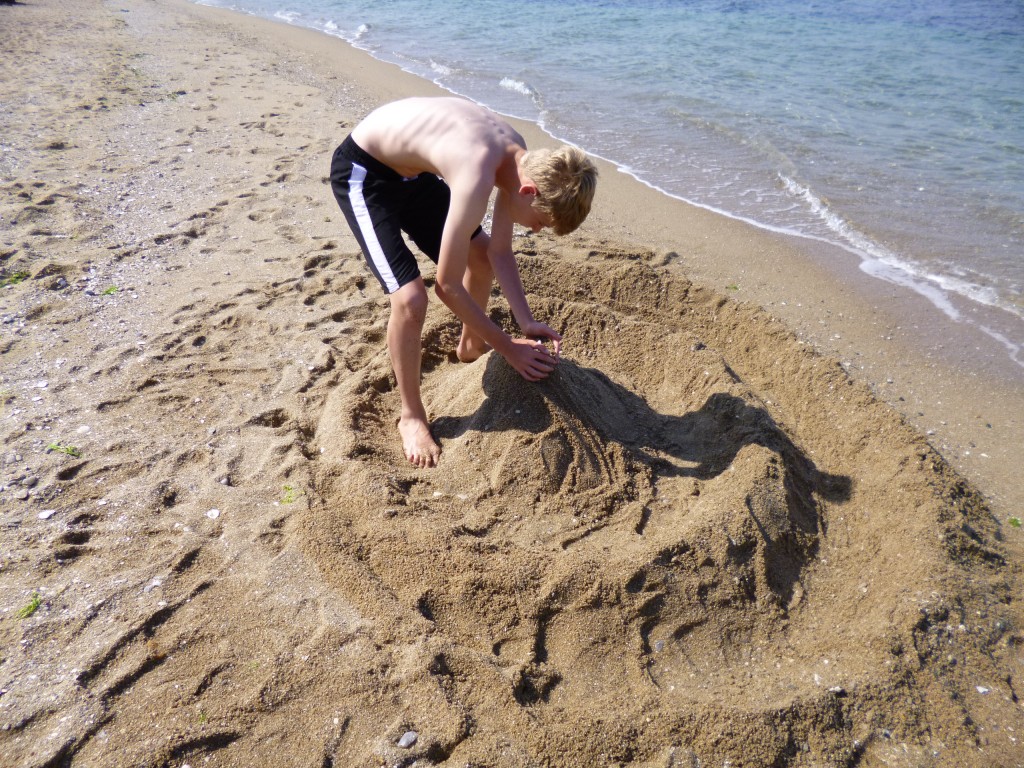 Putting the finishing touches to the sandcastle