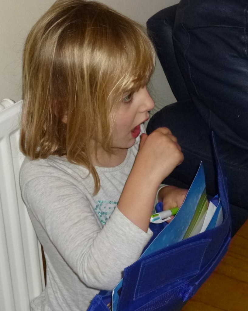 Holding pen but thumb about to go into mouth!