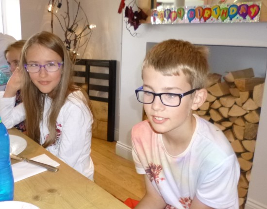 Chris and Sofia - with the birthday banner above them